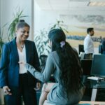 Business team interacting in a modern office setting, showcasing diversity and collaboration.